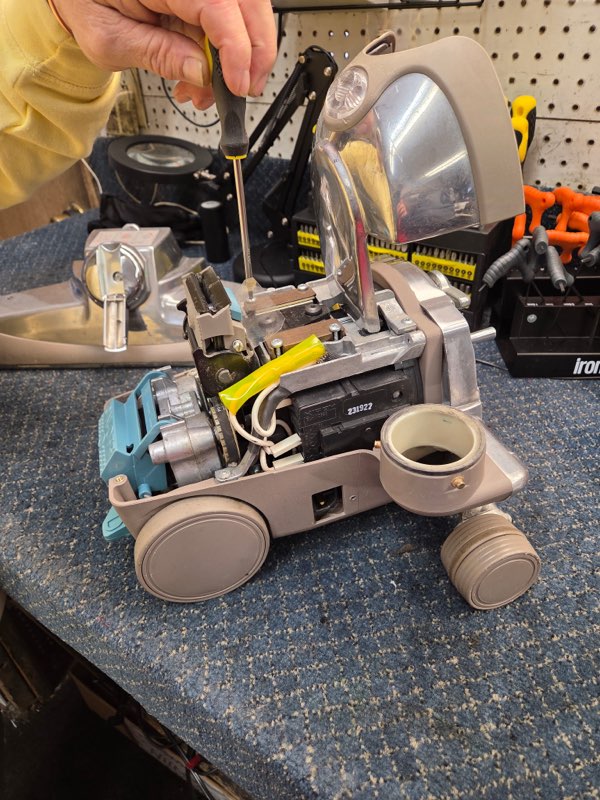 Vacuum technician servicing internal components