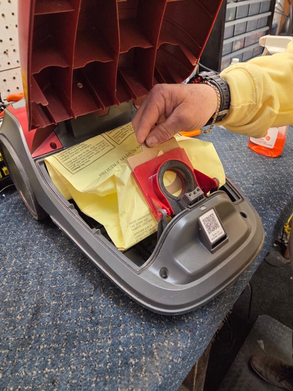 Vacuum cleaner bag compartment being inspected